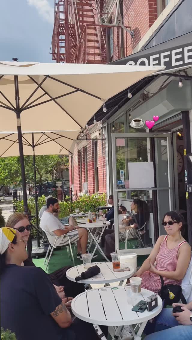 Coffee Ave storefront with umbrellas and sidewalk seating full of neighbors